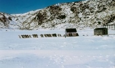 ulling a structure across the ice to Conche, Newfoundland. Resettlement Collection, Maritime History Archive, Memorial University. PF-317.488